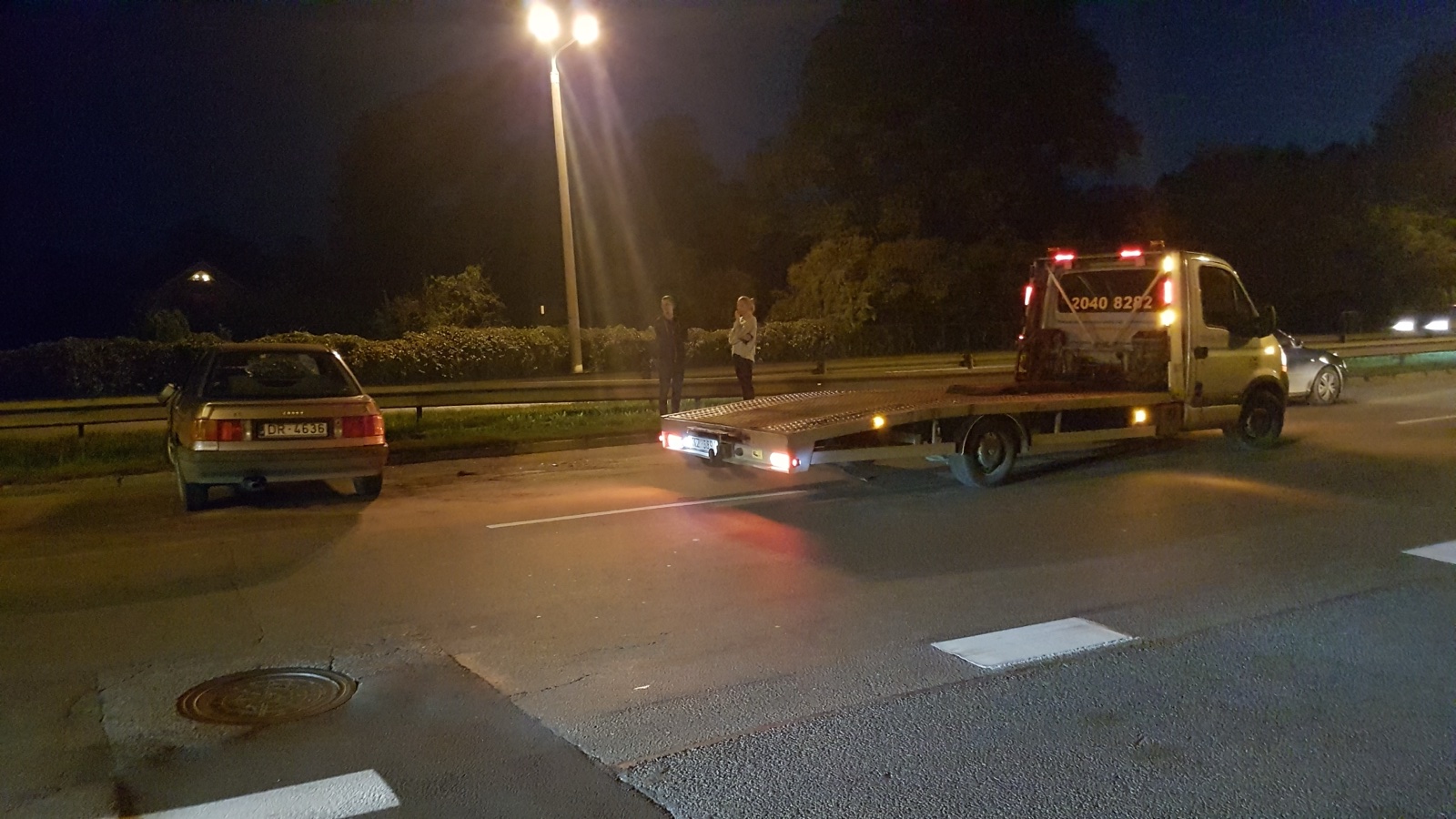 Autoevakuators transportē auto ar nolauztu balstiekārtas atsperi
